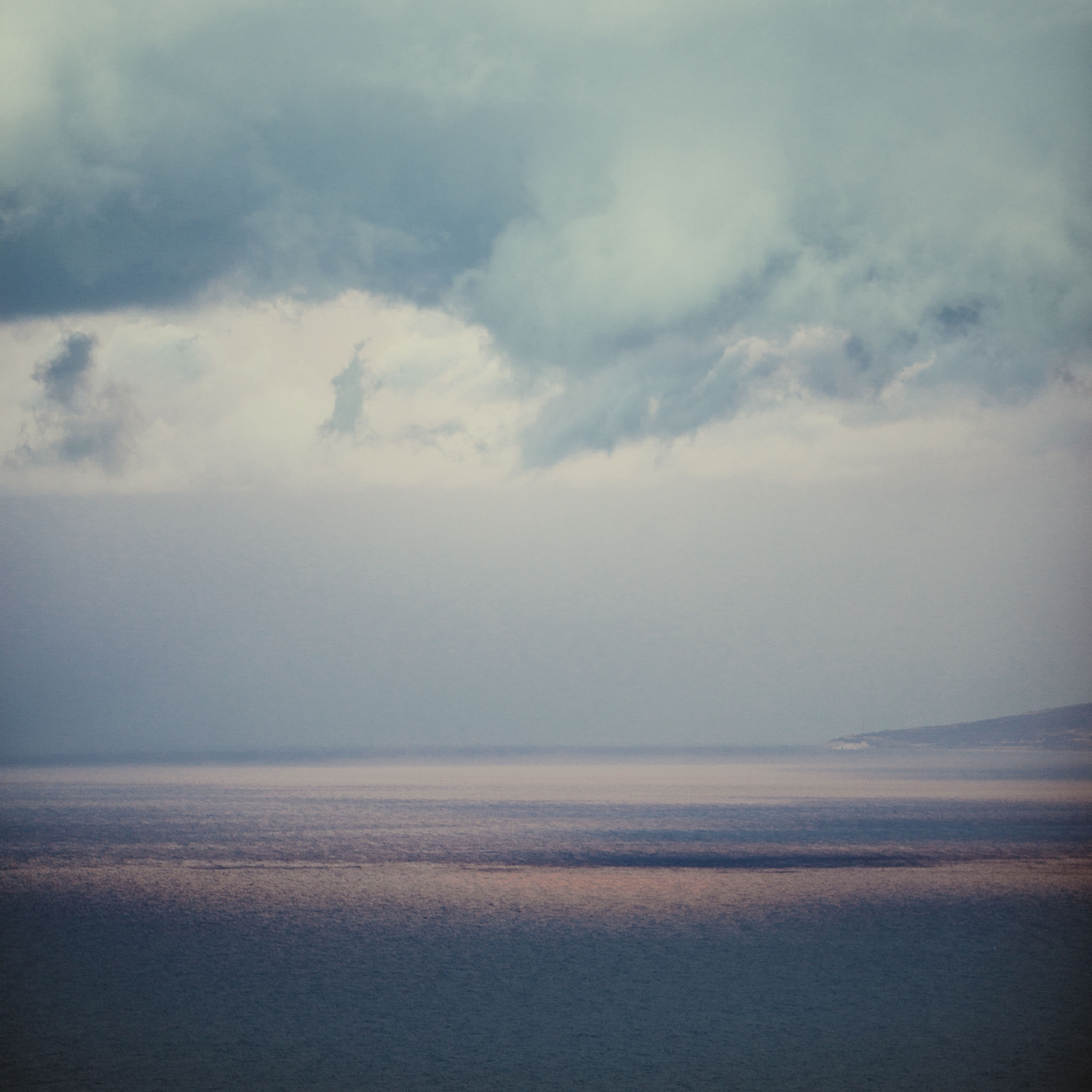 Ocean and sky meeting at a misty horizon